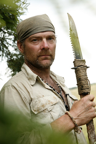 Surviorman Les Stroud holding a knife