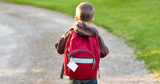 Kid carrying a bug out backpack