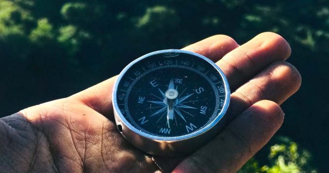 Guy holding a compass